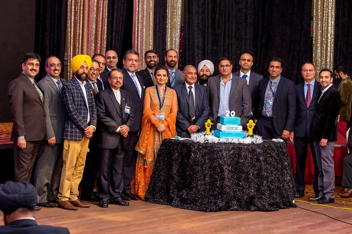 SPEATBC members and leaders gathered around a 20th anniversary cake